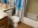 Bright bathroom with a blue beach themed shower curtain and a standard bathtub at 774 E Morningside Dr, Phoenix, AZ 85022