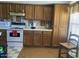 Traditional kitchen featuring wood cabinets, white appliances, and tile countertops at 774 E Morningside Dr, Phoenix, AZ 85022