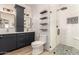 Elegant bathroom featuring a double vanity, modern fixtures, and a stylish, tiled shower at 7858 W Fetlock Trl, Peoria, AZ 85383