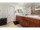 Bathroom featuring double sinks, a large mirror, and ample storage space at 7858 W Fetlock Trl, Peoria, AZ 85383