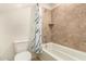 Bathroom with tiled shower and tub combo, toilet and neutral wall tones at 7858 W Fetlock Trl, Peoria, AZ 85383
