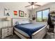 Serene bedroom features a plush bed, nightstand with a lamp, and a window offering natural light at 7858 W Fetlock Trl, Peoria, AZ 85383