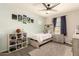 Bedroom features modern decor, carpet flooring, and a ceiling fan at 7858 W Fetlock Trl, Peoria, AZ 85383
