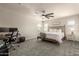 Spacious bedroom featuring a work space and ceiling fan at 7858 W Fetlock Trl, Peoria, AZ 85383