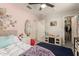 Cozy bedroom with playful decor, featuring carpet flooring and a ceiling fan at 7858 W Fetlock Trl, Peoria, AZ 85383