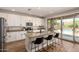 Modern kitchen features a center island, granite countertops, and a view to the backyard pool at 7858 W Fetlock Trl, Peoria, AZ 85383