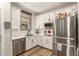 Well-lit kitchen featuring stainless steel appliances, white cabinets, and attractive subway tile backsplash at 7858 W Fetlock Trl, Peoria, AZ 85383