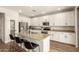 Open concept kitchen featuring a center island, stainless steel appliances, and white cabinets at 7858 W Fetlock Trl, Peoria, AZ 85383