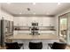 Modern kitchen island with granite countertop and black stools at 7858 W Fetlock Trl, Peoria, AZ 85383
