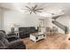 Inviting living room featuring a large ceiling fan and hardwood floors for comfort and style at 7858 W Fetlock Trl, Peoria, AZ 85383