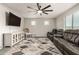 Spacious living room features a fan and a comfortable seating area at 7858 W Fetlock Trl, Peoria, AZ 85383