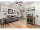 Comfortable living room with a reclining couch, wood floors, and a ceiling fan at 7858 W Fetlock Trl, Peoria, AZ 85383
