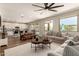 Open living space connecting to the kitchen, featuring hardwood floors and comfortable seating areas at 7858 W Fetlock Trl, Peoria, AZ 85383