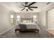 Bright main bedroom with a ceiling fan, large windows, and neutral décor at 7858 W Fetlock Trl, Peoria, AZ 85383