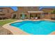 A refreshing private pool is surrounded by a spacious patio, ideal for relaxation and enjoying sunny days at 7858 W Fetlock Trl, Peoria, AZ 85383