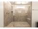 Large walk-in shower with neutral-colored tile and a built-in bench at 7858 W Fetlock Trl, Peoria, AZ 85383