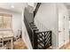 View of the staircase featuring carpeted steps, wooden railings, and a decorative safety gate at 7858 W Fetlock Trl, Peoria, AZ 85383