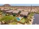 Bird's eye view of a home with a pool, putting green, covered patio, and desert landscaping at 8304 E Inca St, Mesa, AZ 85207