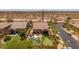 Aerial view of a well-maintained backyard featuring a pool, putting green, outdoor seating, and mature trees at 8304 E Inca St, Mesa, AZ 85207