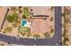 High angle view of a backyard with a pool, putting green, patio set, and neighboring properties at 8304 E Inca St, Mesa, AZ 85207
