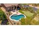 Aerial view showcasing a backyard with a private pool, putting green, covered patio, and outdoor dining area at 8304 E Inca St, Mesa, AZ 85207