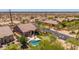 Aerial view of a desert home with a private pool, putting green, and patio in a fenced backyard oasis at 8304 E Inca St, Mesa, AZ 85207