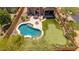 Aerial view of a private backyard featuring a pool, putting green, covered patio, and lush landscaping at 8304 E Inca St, Mesa, AZ 85207