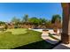 Expansive backyard featuring a putting green, pool, and fire pit, creating the ultimate outdoor retreat at 8304 E Inca St, Mesa, AZ 85207