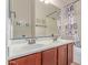 Bathroom with double sink vanity, white countertop, and decorative mirror at 8304 E Inca St, Mesa, AZ 85207