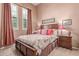 Bedroom featuring coordinated lamps, comfortable bed, and window shutters at 8304 E Inca St, Mesa, AZ 85207