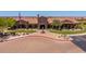 Aerial of a clubhouse with a large American flag and desert landscaping in a sunny neighborhood at 8304 E Inca St, Mesa, AZ 85207