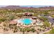 Aerial view of a sparkling community pool with comfortable seating and lush desert landscaping at 8304 E Inca St, Mesa, AZ 85207