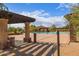 Community pool with multiple swimming lanes, pergola and desert landscaping around the deck at 8304 E Inca St, Mesa, AZ 85207