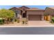 Inviting single-Gathering home with desert landscaping, a brick driveway, and a cozy covered porch at 8304 E Inca St, Mesa, AZ 85207