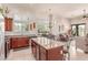 Bright kitchen with a large center island, granite countertops, and stainless steel appliances overlooking the dining and living area at 8304 E Inca St, Mesa, AZ 85207