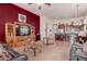Spacious open-concept living area with modern decor, a large TV, and seamless flow into the kitchen at 8304 E Inca St, Mesa, AZ 85207