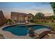 Inviting backyard oasis with a sparkling pool, fire pit, putting green and outdoor seating area for relaxing evenings at 8304 E Inca St, Mesa, AZ 85207