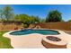 Stunning backyard pool with waterfall feature and fire pit area at 8304 E Inca St, Mesa, AZ 85207