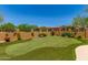 Backyard putting green with manicured landscaping and privacy fence at 8304 E Inca St, Mesa, AZ 85207