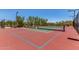 Well-maintained tennis court surrounded by lush landscaping and fencing at 8304 E Inca St, Mesa, AZ 85207