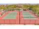 An aerial view of pristine tennis courts in a well-maintained residential community at 8304 E Inca St, Mesa, AZ 85207