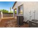 The backyard featuring a block fence, open dirt area, and Lennox air conditioning unit for a comfortable outdoor space at 9249 E Sector Dr, Mesa, AZ 85212