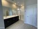 Modern bathroom features double sinks, glass-enclosed shower, tile flooring, and ample lighting, offering a luxurious and functional space at 9249 E Sector Dr, Mesa, AZ 85212
