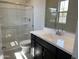 Bright bathroom features a glass-enclosed shower, sleek vanity, and a large mirror, offering a clean and modern design at 9249 E Sector Dr, Mesa, AZ 85212