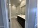 Bathroom featuring a double sink vanity, tub and shower, and tile flooring, providing a functional and stylish space at 9249 E Sector Dr, Mesa, AZ 85212