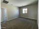 Spacious bedroom featuring soft carpeting, neutral walls, and a large window, creating a comfortable and relaxing living space at 9249 E Sector Dr, Mesa, AZ 85212