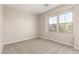 Bright bedroom with carpeted floors, dual windows overlooking the neighborhood, and neutral paint at 9249 E Sector Dr, Mesa, AZ 85212