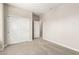 Bedroom with closet doors and open door with neutral carpeted floors and neutral-colored walls at 9249 E Sector Dr, Mesa, AZ 85212