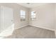 Cozy bedroom featuring two windows for natural light and a door for easy access at 9249 E Sector Dr, Mesa, AZ 85212