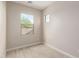 Bedroom with wood-look flooring, two windows facing the backyard, and neutrally painted walls at 9249 E Sector Dr, Mesa, AZ 85212